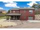 A multi-story house with well-maintained exteriors, a porch and large surrounding yard at 826 Meadow Ln, Palmer Lake, CO 80133