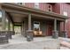 Charming covered front porch with stone pillars and cozy bench seating at 826 Meadow Ln, Palmer Lake, CO 80133