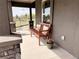 Inviting front porch with bench and flowers. Relax and enjoy the scenery at 826 Meadow Ln, Palmer Lake, CO 80133