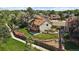 Aerial view of a spacious backyard with a deck, patio, fire pit, and tiered landscaping at 11149 Seton Pl, Westminster, CO 80031