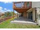 Covered backyard patio with deck above, concrete base, and view of the fenced backyard at 11149 Seton Pl, Westminster, CO 80031