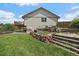 Rear exterior view of a well-maintained yard, deck, patio, and exterior stairs at 11149 Seton Pl, Westminster, CO 80031