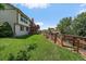 Spacious backyard featuring a lush lawn, wood fence, mature trees and landscaping and home exterior at 11149 Seton Pl, Westminster, CO 80031