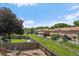 Fenced backyard with a large grassy area, mature trees, and neighboring houses at 11149 Seton Pl, Westminster, CO 80031