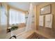 Bathroom showcasing a bathtub with shower, decorative tile accent and neutral color palette at 11149 Seton Pl, Westminster, CO 80031