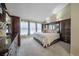 Serene bedroom with neutral tones, large bed, and ample natural light from large windows at 11149 Seton Pl, Westminster, CO 80031