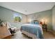 Serene bedroom featuring natural lighting, a comfortable rocking chair, and a soft blue color palette at 11149 Seton Pl, Westminster, CO 80031