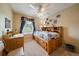 Inviting bedroom with a wooden bed frame, built-in drawers, and a well-lit study desk at 11149 Seton Pl, Westminster, CO 80031