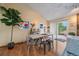 Bright dining room featuring hardwood floors, modern art, and sliding glass door to outdoor patio at 11149 Seton Pl, Westminster, CO 80031