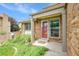 Charming front porch with brick accents, a red door, and well-maintained landscaping at 11149 Seton Pl, Westminster, CO 80031