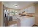 Bright kitchen with stainless steel appliances, white cabinets, and a cozy breakfast bar at 11149 Seton Pl, Westminster, CO 80031