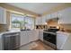 Bright kitchen featuring stainless steel appliances, ample countertop space, and natural light from large window at 11149 Seton Pl, Westminster, CO 80031