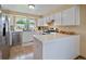 Well-lit kitchen featuring white cabinets, stainless steel appliances, and quartz countertops at 11149 Seton Pl, Westminster, CO 80031