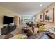 Open living area with a wet bar, cozy leather seating, and a mounted flat-screen TV at 11149 Seton Pl, Westminster, CO 80031