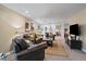 Spacious living room with leather seating, neutral walls, and a stylish area rug at 11149 Seton Pl, Westminster, CO 80031