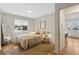Bright bedroom with hardwood floors, window, and walk-in closet at 2800 N Harrison St, Denver, CO 80205