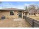 Well-maintained brick home with a cozy, fenced front yard, a modern door, and fresh landscaping at 2800 N Harrison St, Denver, CO 80205
