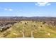 Elevated view of a meticulously designed golf course with the city skyline in the background at 2800 N Harrison St, Denver, CO 80205