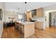 Open concept kitchen features a large island, modern cabinets, and hardwood floors at 2800 N Harrison St, Denver, CO 80205