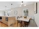 Open concept kitchen and dining area with an island, hardwood floors and natural light at 2800 N Harrison St, Denver, CO 80205