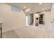 Finished basement area featuring neutral carpet, sliding door, and staircase at 8982 Spaulding St, Parker, CO 80134