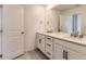 Bright bathroom featuring double sinks with a large mirror and ample counter space at 8982 Spaulding St, Parker, CO 80134