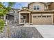 Inviting two-story home featuring a charming front porch and a convenient two-car garage at 8982 Spaulding St, Parker, CO 80134