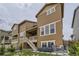 Rear exterior of a multi-story home with a private balcony and landscaped yard at 8982 Spaulding St, Parker, CO 80134