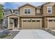 Inviting two-story home featuring a two-car garage, stone landscaping and cozy front porch at 8982 Spaulding St, Parker, CO 80134