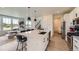 Open-concept kitchen featuring stainless steel appliances, quartz counters, and island with seating at 8982 Spaulding St, Parker, CO 80134