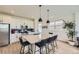 Modern kitchen featuring an island with seating, stainless steel appliances, and bright cabinets at 8982 Spaulding St, Parker, CO 80134