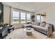 Bright living room featuring a comfortable sectional sofa and large windows overlooking the backyard at 8982 Spaulding St, Parker, CO 80134