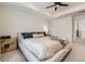 A main bedroom features a tray ceiling, ceiling fan, and neutral decor at 8982 Spaulding St, Parker, CO 80134