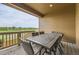 Covered patio with wood-look flooring, features outdoor dining table and chairs with scenic views at 8982 Spaulding St, Parker, CO 80134
