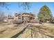 Beautiful backyard of home featuring a stone patio, mature trees, and lush landscaping at 6406 Eagle Ct, Longmont, CO 80503