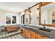 Luxurious bathroom featuring a copper soaking tub, double vanity with industrial style and large windows at 6406 Eagle Ct, Longmont, CO 80503