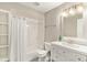 Bright bathroom featuring a tub with shower, white vanity, and ample shelving providing storage at 6406 Eagle Ct, Longmont, CO 80503