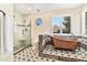 Beautifully designed bathroom featuring a copper soaking tub, stylish tilework, and glass-enclosed shower at 6406 Eagle Ct, Longmont, CO 80503
