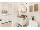 Charming bathroom with modern fixtures, storage, and laundry area at 6406 Eagle Ct, Longmont, CO 80503
