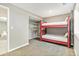 Charming bedroom featuring a red bunk bed, closet with shelving, and soft carpet in neutral tones at 6406 Eagle Ct, Longmont, CO 80503