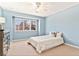 Bright bedroom with light blue walls, large window with mountain views, and ample natural light at 6406 Eagle Ct, Longmont, CO 80503