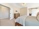 A neutral bedroom featuring an inviting bed, wooden dresser, and ample space for relaxation at 6406 Eagle Ct, Longmont, CO 80503