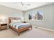 Clean and comfortable bedroom with neutral walls, a large window, and minimalist decor at 6406 Eagle Ct, Longmont, CO 80503