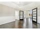 Bright dining room with chandelier, modern doors, wainscoting and dark hardwood floors at 6406 Eagle Ct, Longmont, CO 80503