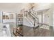 Elegant living room boasts dark hardwood floors, staircase, and open layout for seamless entertaining at 6406 Eagle Ct, Longmont, CO 80503