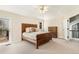 Beautiful main bedroom with wood headboard, balcony access, and lots of natural light at 6406 Eagle Ct, Longmont, CO 80503