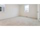 Neutral bedroom with two large windows and plush carpeting at 6500 13Th St, Frederick, CO 80530