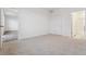 Clean bedroom with carpet, white walls, and access to a tiled bathroom at 6500 13Th St, Frederick, CO 80530