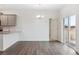 Bright dining room with slider door, modern chandelier, and wood grain flooring at 6500 13Th St, Frederick, CO 80530