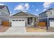 Charming single-story home with gray siding, stone accents, and a two-car garage at 6500 13Th St, Frederick, CO 80530